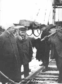 Mayor Deacon driving the last spike - December 1914
