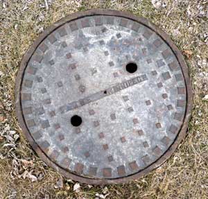 Solid manhole cover in boulevard photo